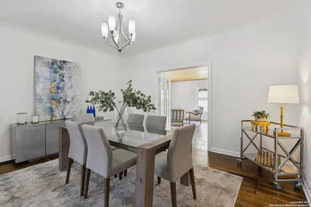 a dining room with furniture a rug and a chandelier