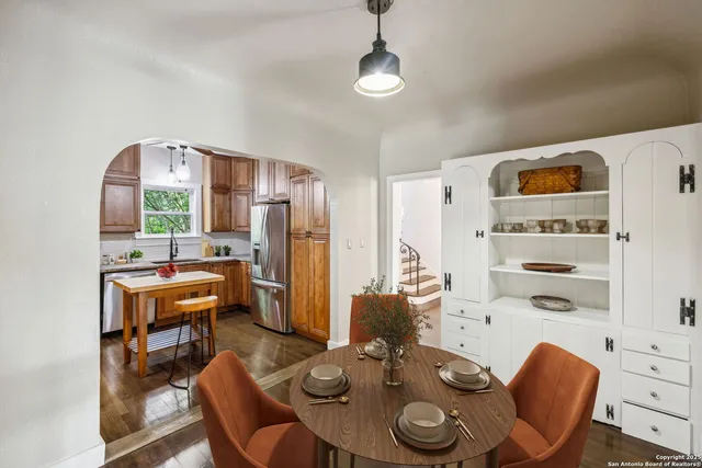a dining room with furniture and window