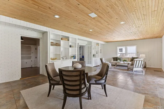 a view of a dining room with furniture and window
