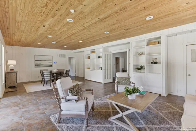 a room with furniture and view of kitchen