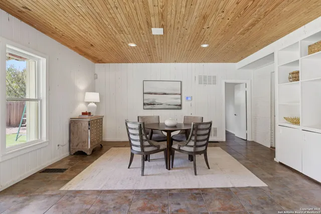 a view of a dining room with furniture and window