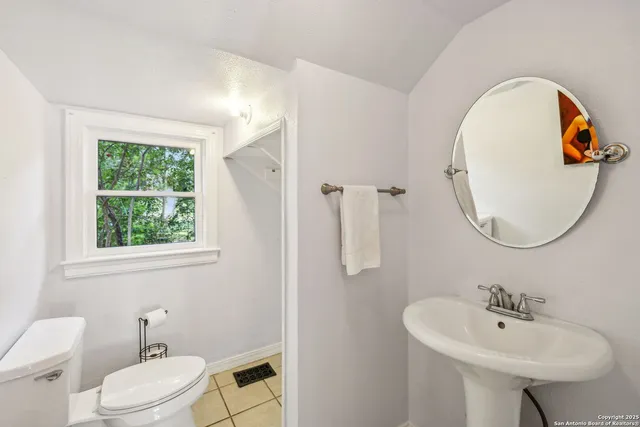 a bathroom with a sink a mirror and a toilet