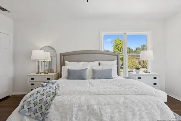 a bedroom with a bed and a window