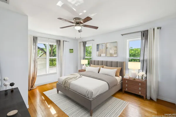 a bedroom with a large bed and a window