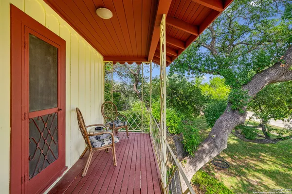 a view of balcony with furniture and garden