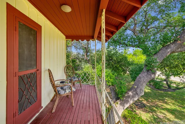 a view of balcony with furniture and garden