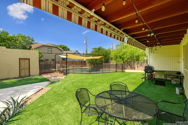 a view of a porch with furniture and a yard