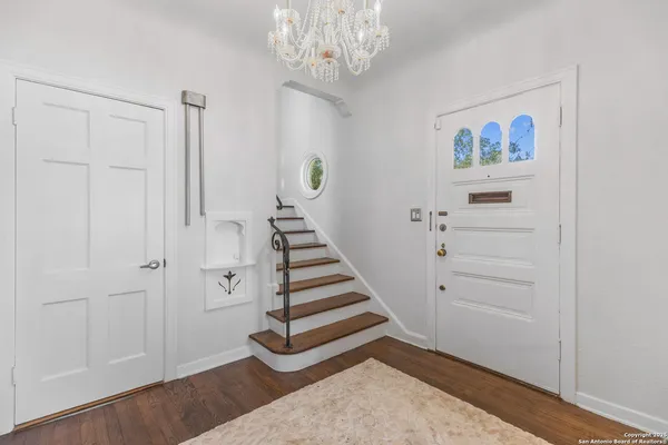 wooden floor in an empty room and a chandelier fan
