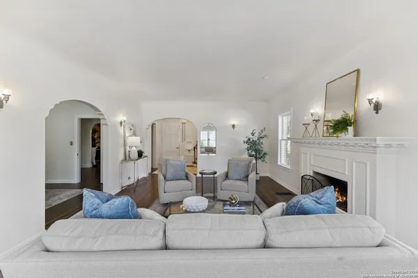 a living room with furniture and a fireplace