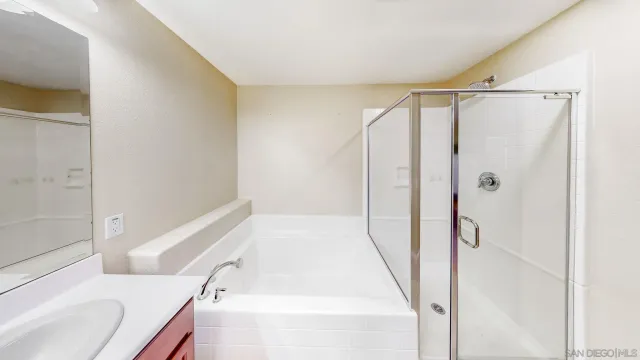 a bathroom with a bathtub and a shower