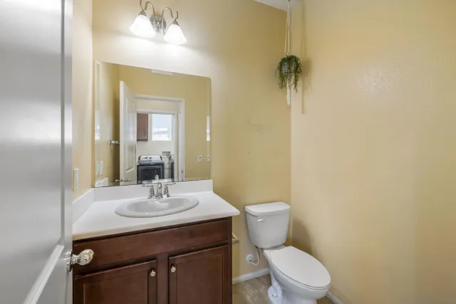 a bathroom with a toilet a sink and mirror