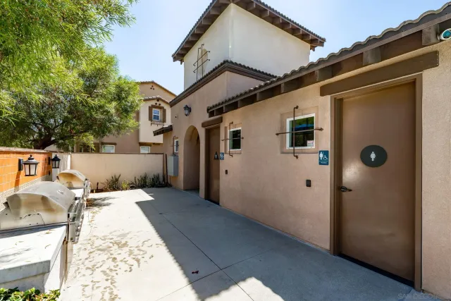 a front view of a house with yard and trees