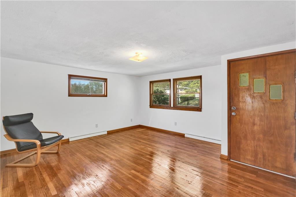 125 Mary Reed Road Baden, PA 15005 - Photo 3 of 31 a view of empty room with wooden floor and fan