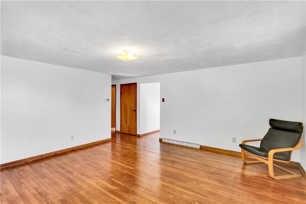 125 Mary Reed Road Baden, PA 15005 - Photo 7 of 31 a view of an empty room with wooden floor