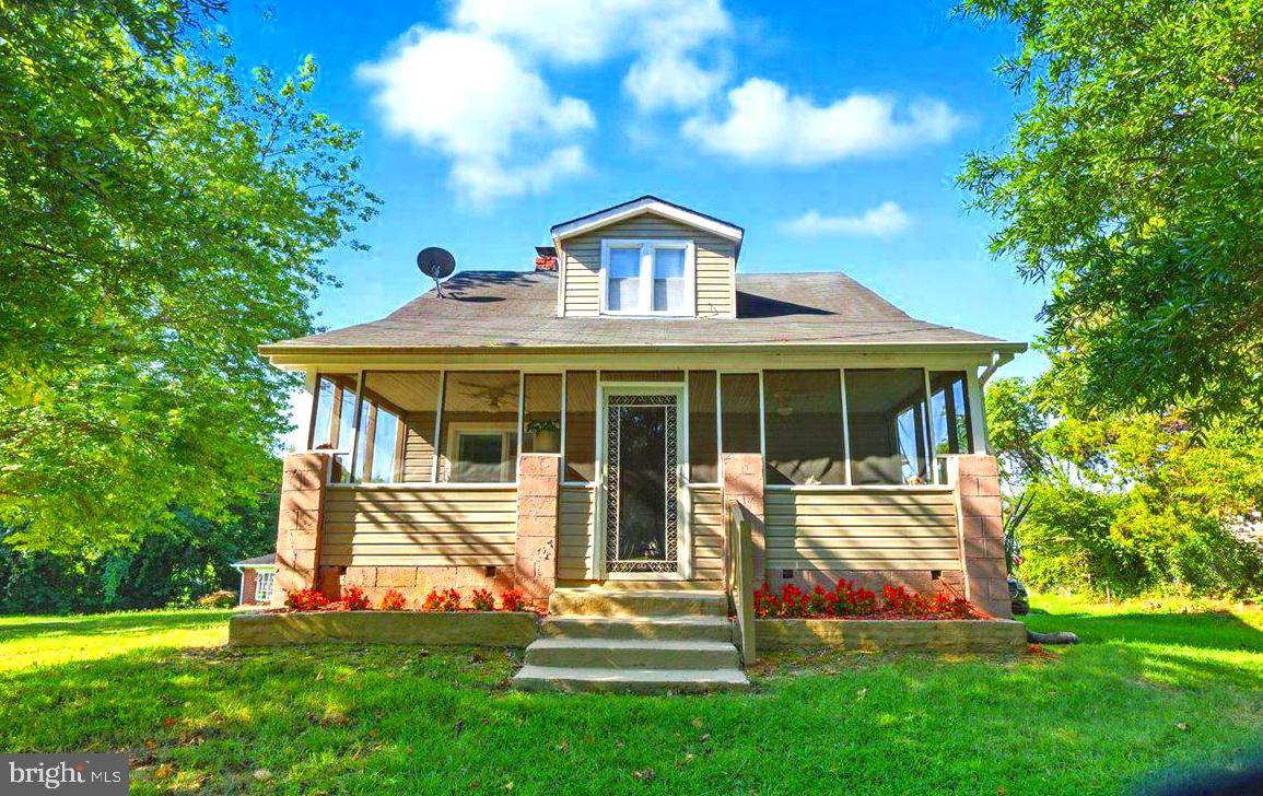 a front view of a house with a yard and porch