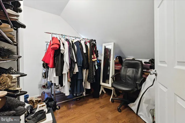 a view of walk in closet with clothes
