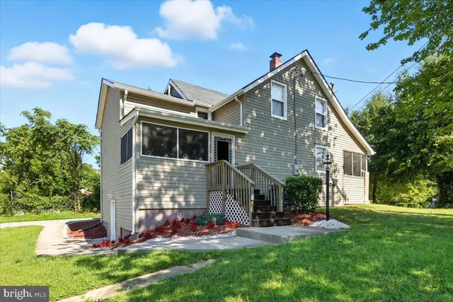 a view of a house with a yard and sitting area
