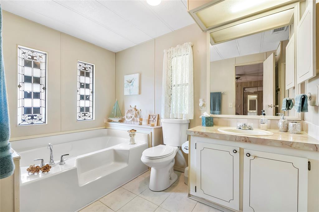 8600 Southwest 16th Place Davie, FL 33324 - Photo 11 of 20 a bathroom with a granite countertop sink mirror and a bathtub