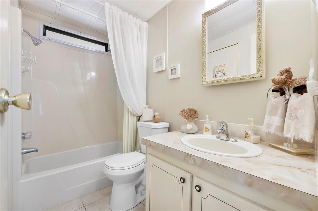8600 Southwest 16th Place Davie, FL 33324 - Photo 12 of 20 a bathroom with a sink a toilet and a mirror