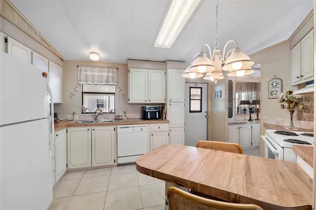 a kitchen with stainless steel appliances a stove refrigerator sink and cabinets