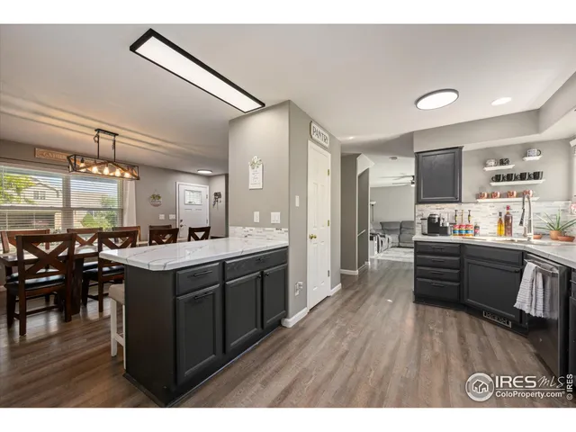 a large kitchen with lots of counter top space and stainless steel appliances