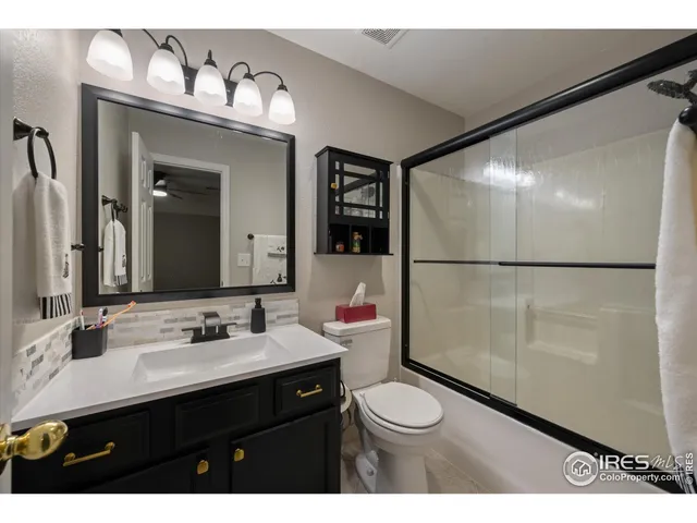 a bathroom with a sink vanity mirror and toilet