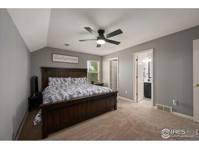 a bedroom with a bed and a ceiling fan