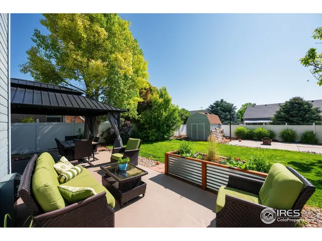 a view of a bench in back yard of the house