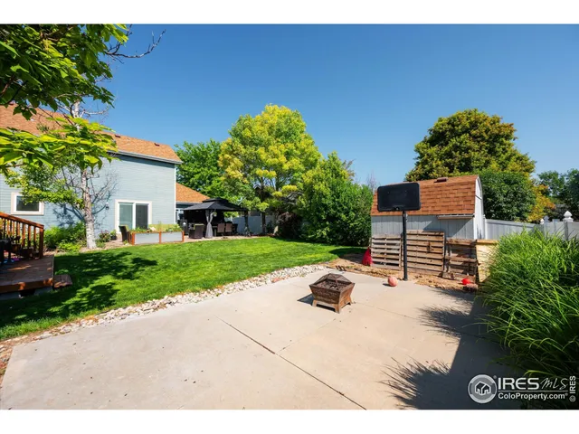 a view of backyard of house with outdoor seating