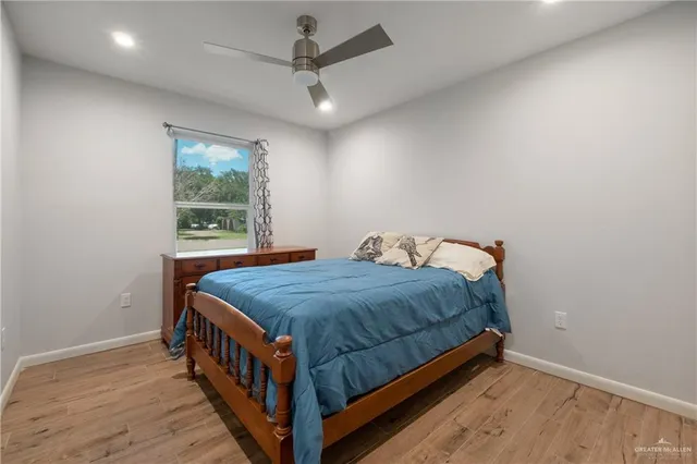 a bed sitting in a bedroom next to a window