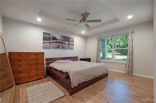 a bedroom with a large bed and a window
