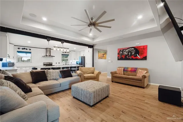 a living room with furniture and wooden floor
