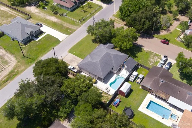 an aerial view of a house with a yard