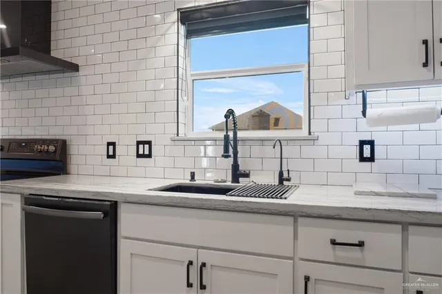 a kitchen with a sink and a potted plant