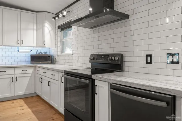 a kitchen with a sink cabinets and appliances