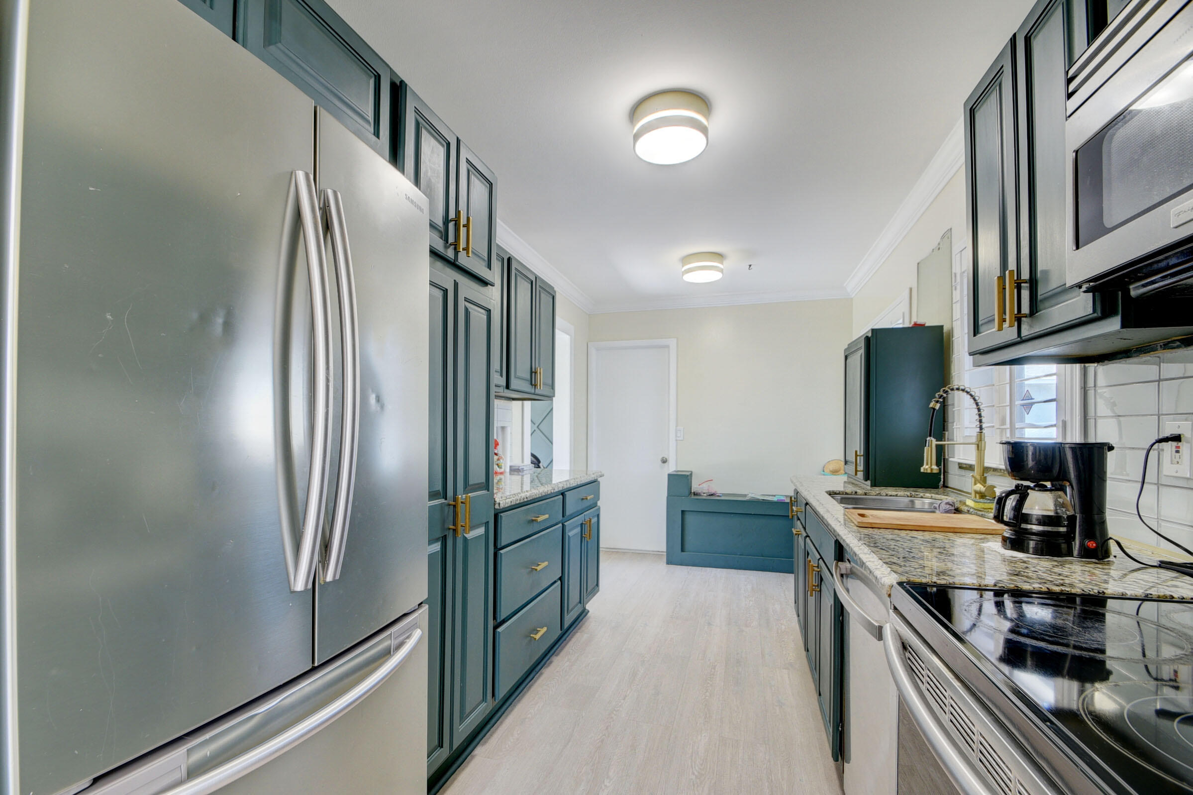 7258 Pine Manor Drive Lake Worth, FL 33467 - Photo 13 of 39 a kitchen with stainless steel appliances granite countertop a refrigerator stove and sink