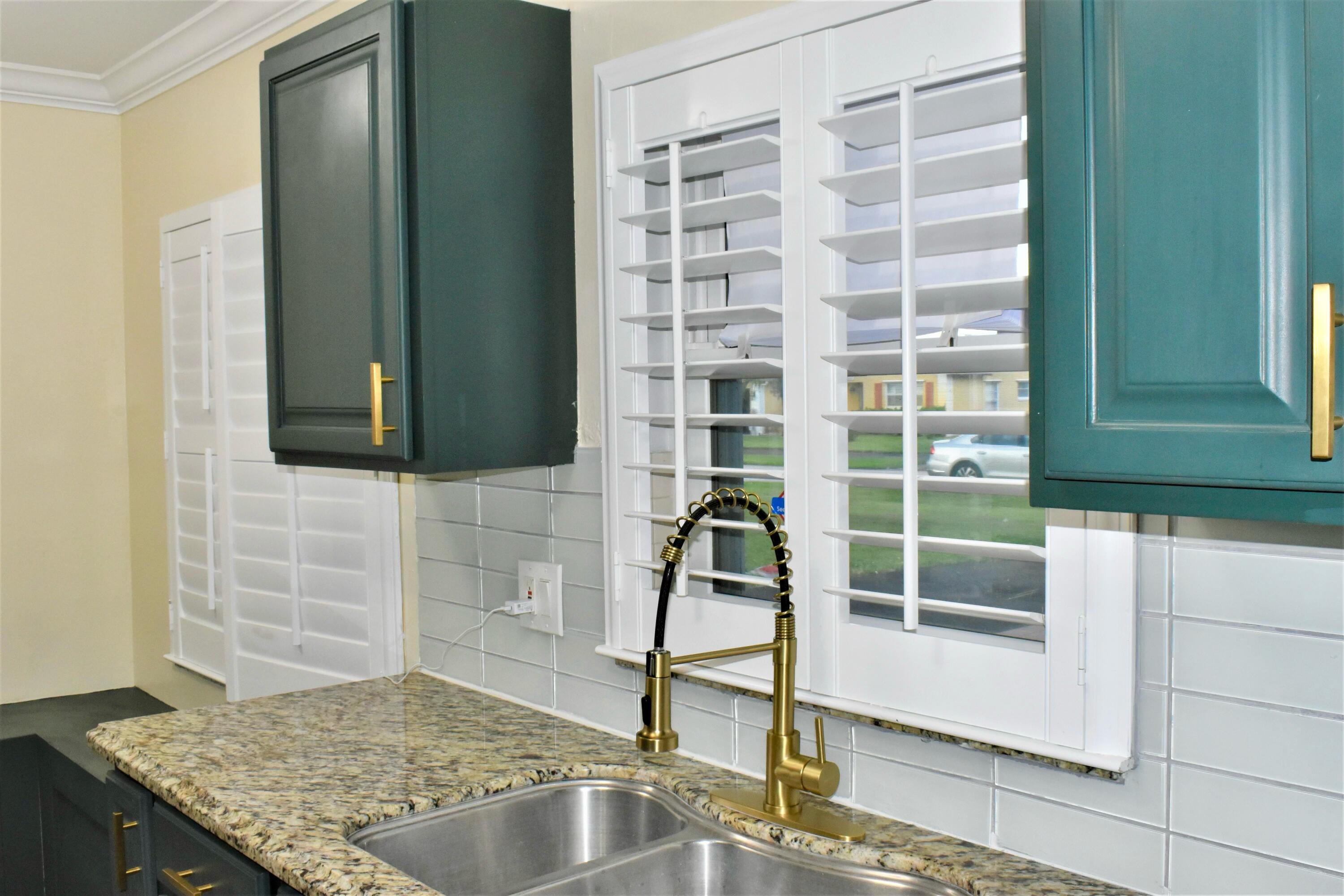 7258 Pine Manor Drive Lake Worth, FL 33467 - Photo 14 of 39 a bathroom with a granite countertop sink and a mirror