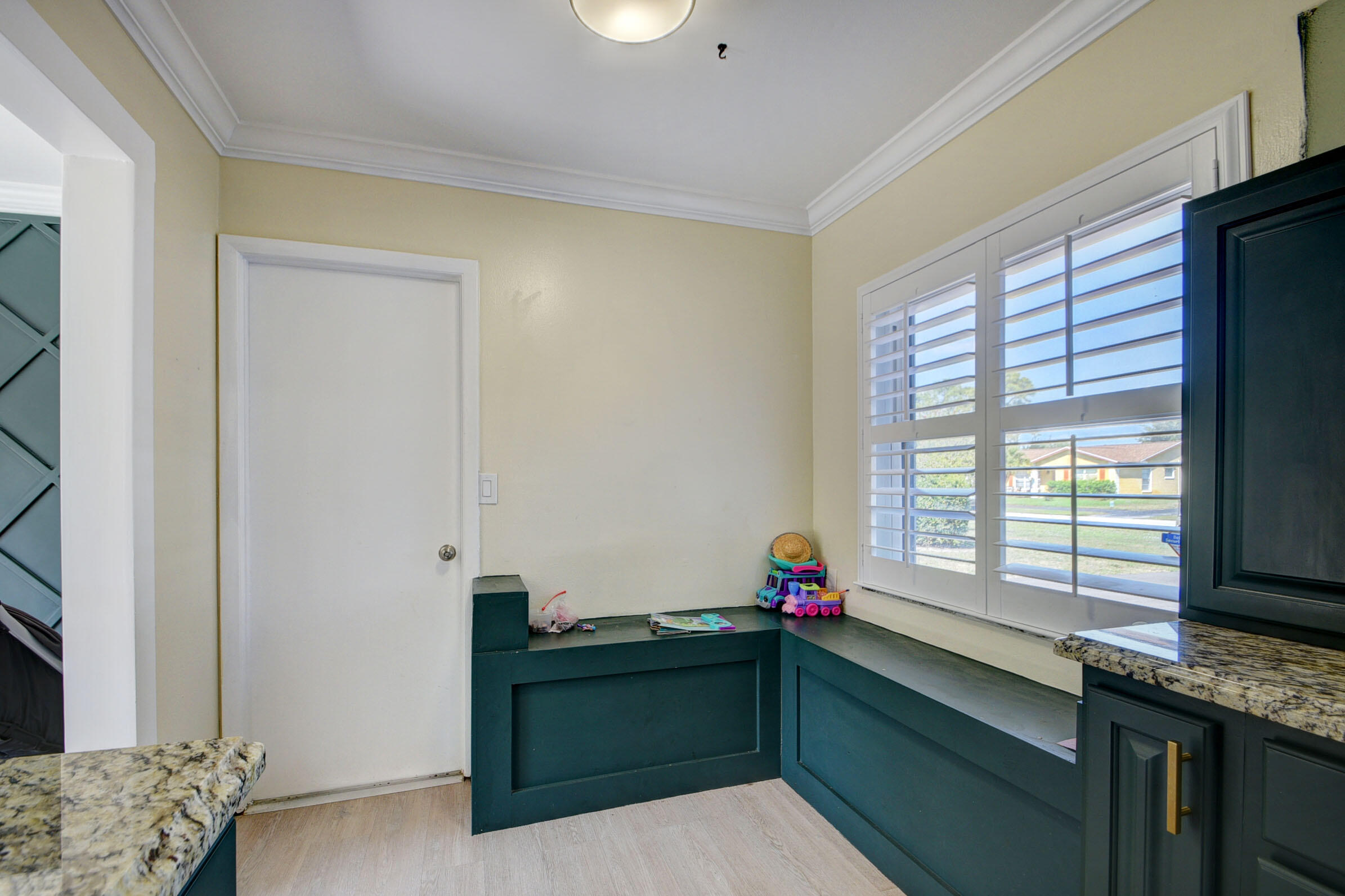7258 Pine Manor Drive Lake Worth, FL 33467 - Photo 15 of 39 a kitchen with granite countertop a sink dishwasher stove and cabinets