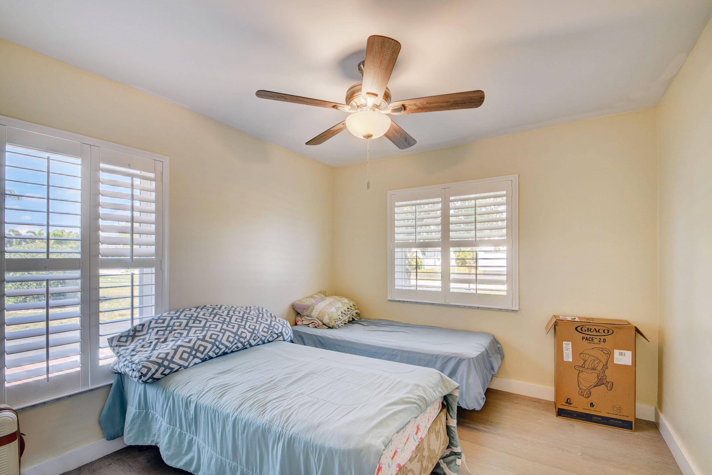 7258 Pine Manor Drive Lake Worth, FL 33467 - Photo 20 of 39 a bedroom with two beds and a window