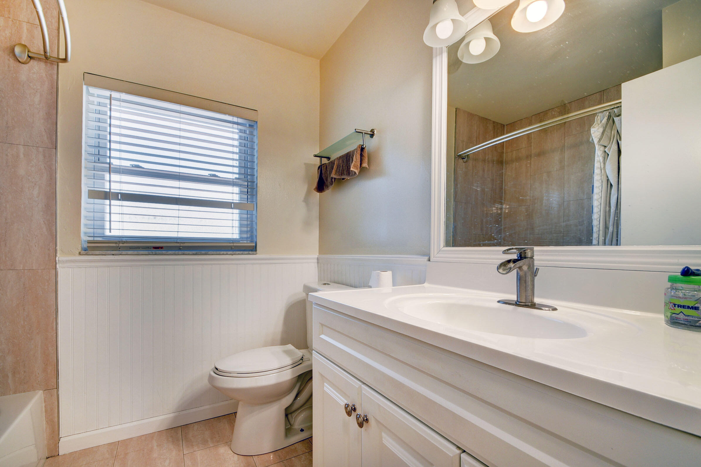 7258 Pine Manor Drive Lake Worth, FL 33467 - Photo 22 of 39 a bathroom with a sink a toilet and mirror