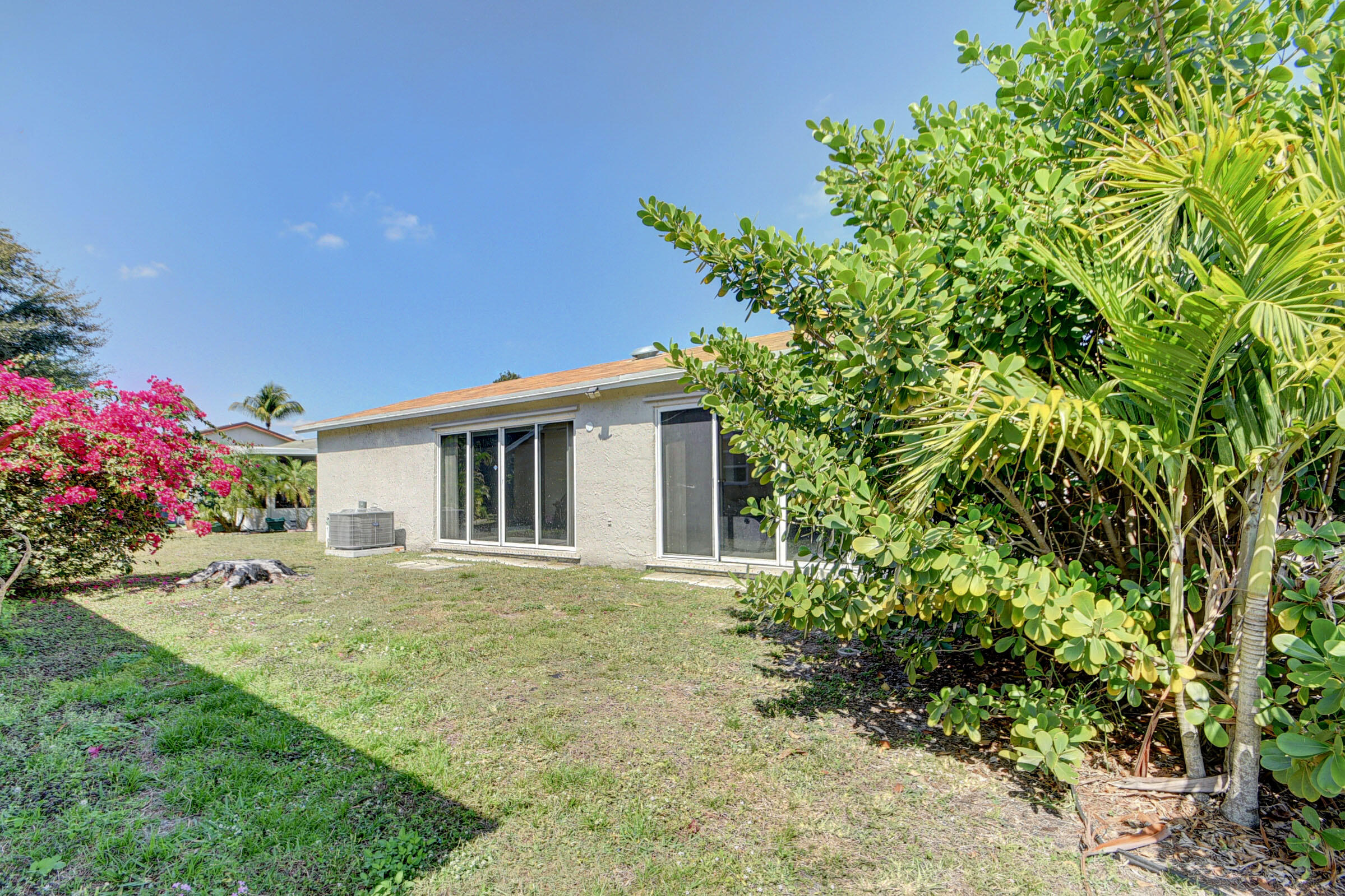 7258 Pine Manor Drive Lake Worth, FL 33467 - Photo 25 of 39 a view of a house with a yard and garden