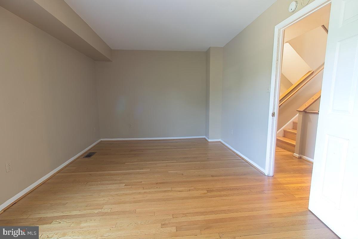 9054 Canterbury Riding, Unit 147 Laurel, MD 20723 - Photo 10 of 15 a view of empty room with wooden floor and fan