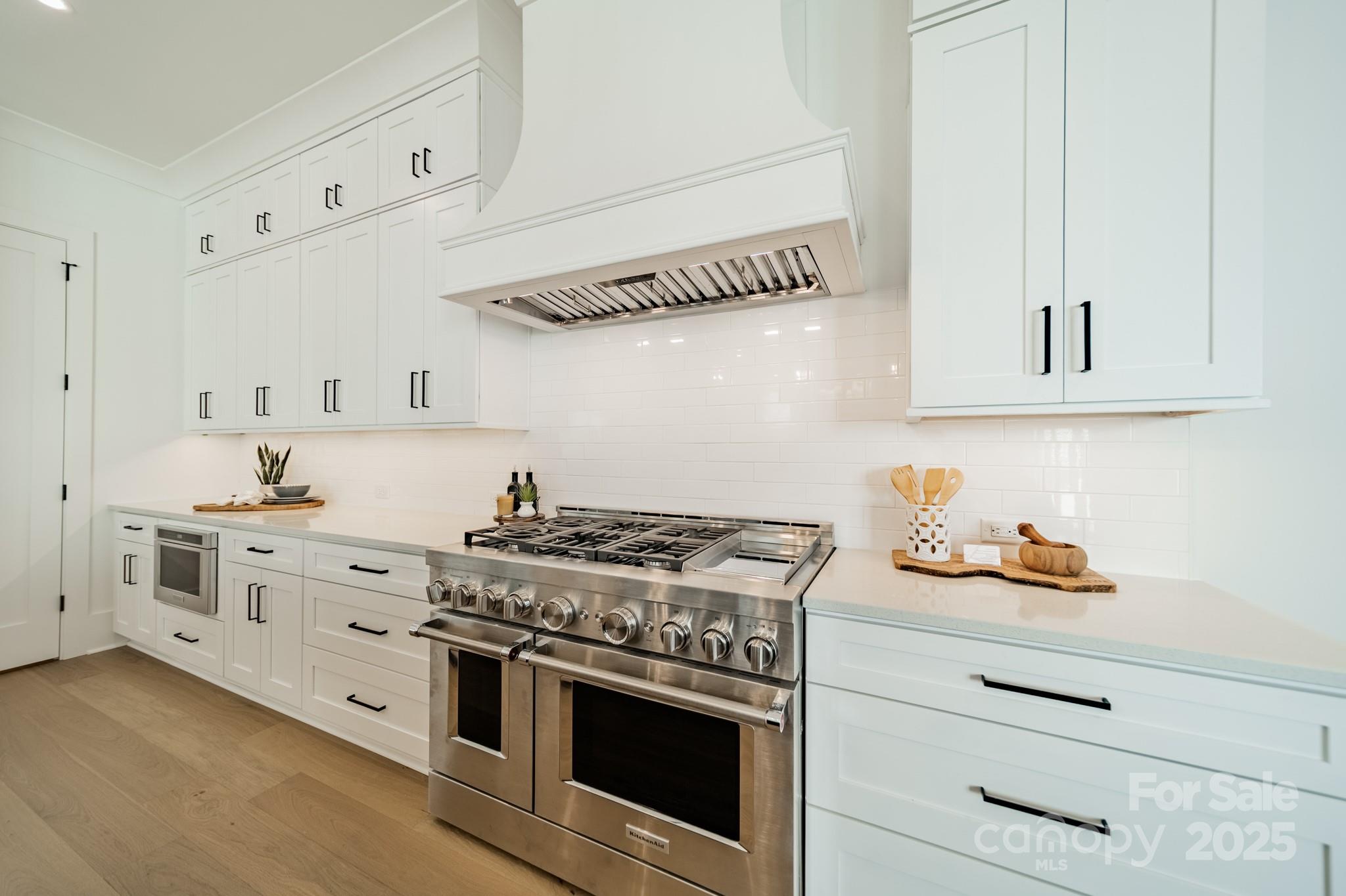 19032 Newburg Hill Road, Unit 23 Davidson, NC 28036 - Photo 9 of 39 a kitchen with white cabinets and appliances