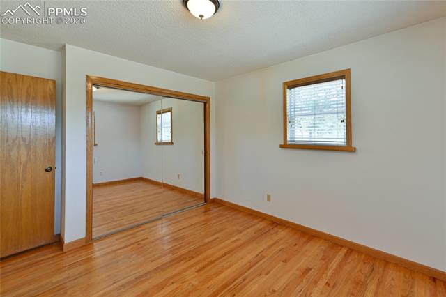 15445 Raton Road Colorado Springs, CO 80921 - Photo 24 of 46 Bedroom #2 has large closet and hardwood floors