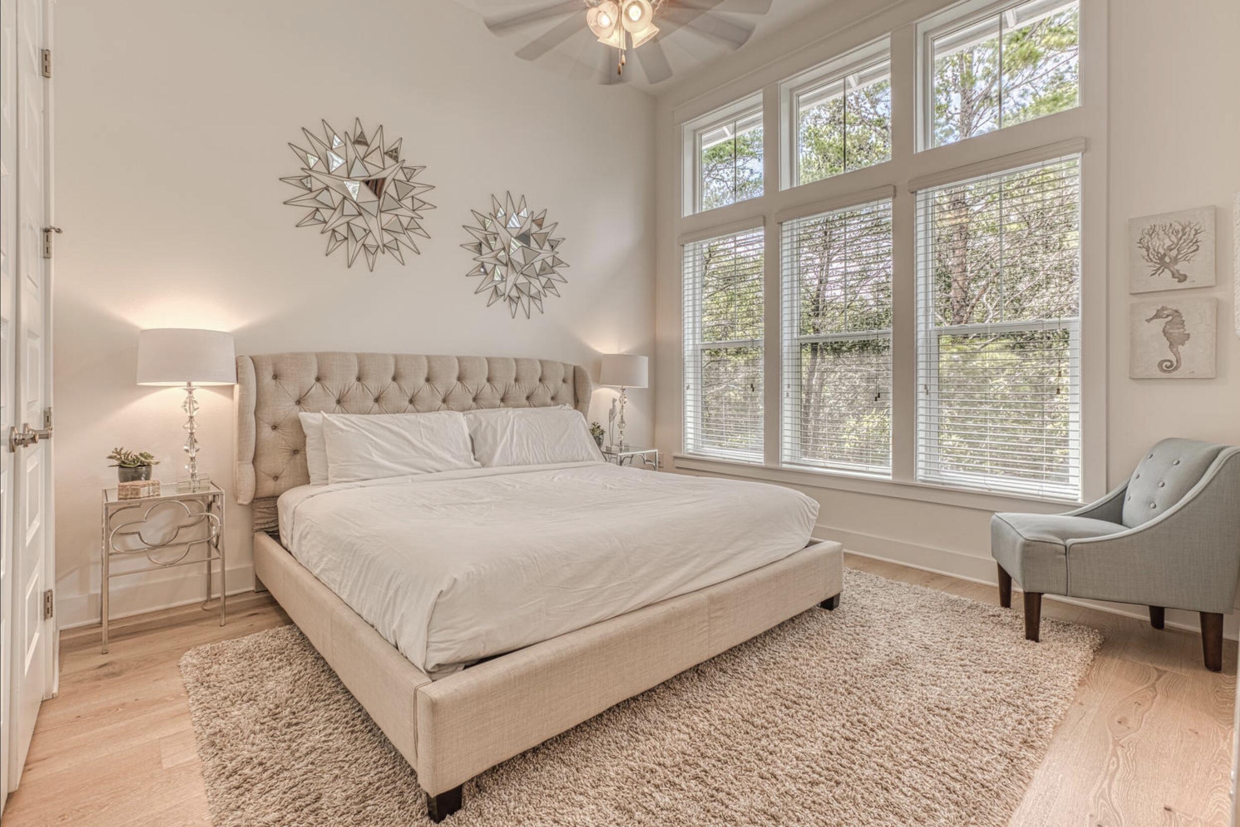 209 Milestone Dr Inlet Beach, Unit B Inlet Beach, FL 32461 - Photo 13 of 39 a bedroom with a large bed and a chandelier