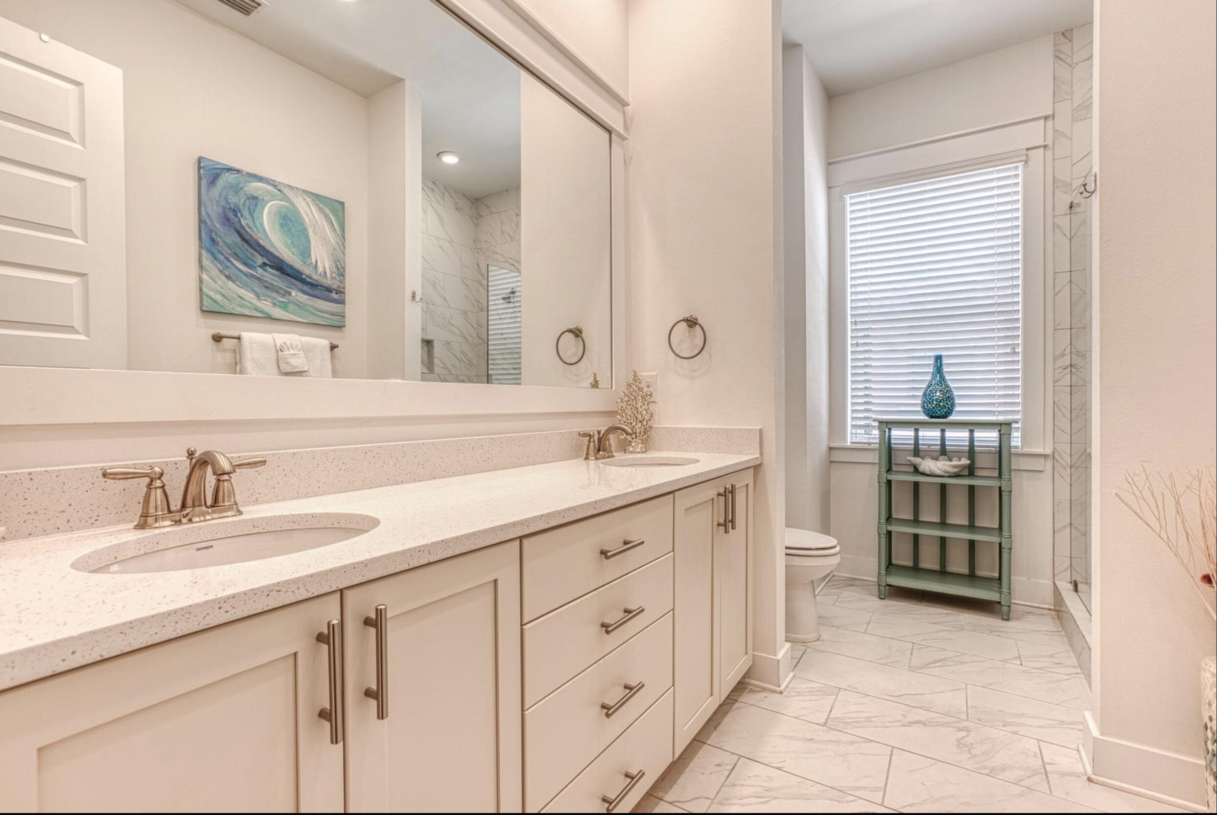 209 Milestone Dr Inlet Beach, Unit B Inlet Beach, FL 32461 - Photo 15 of 39 a spacious bathroom with a double vanity sink double and a mirror