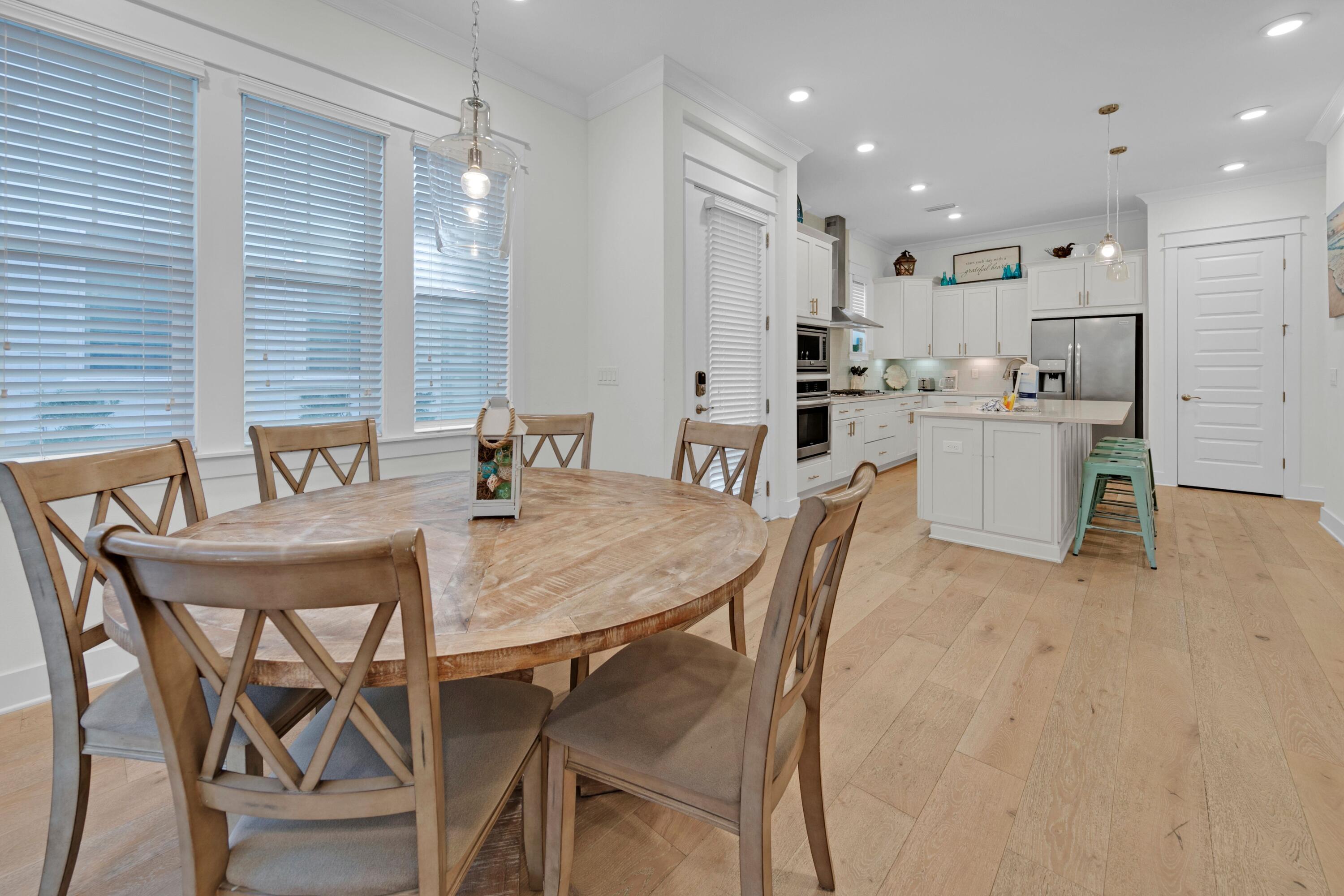 209 Milestone Dr Inlet Beach, Unit B Inlet Beach, FL 32461 - Photo 18 of 39 a dining room with kitchen island a table and chairs in it