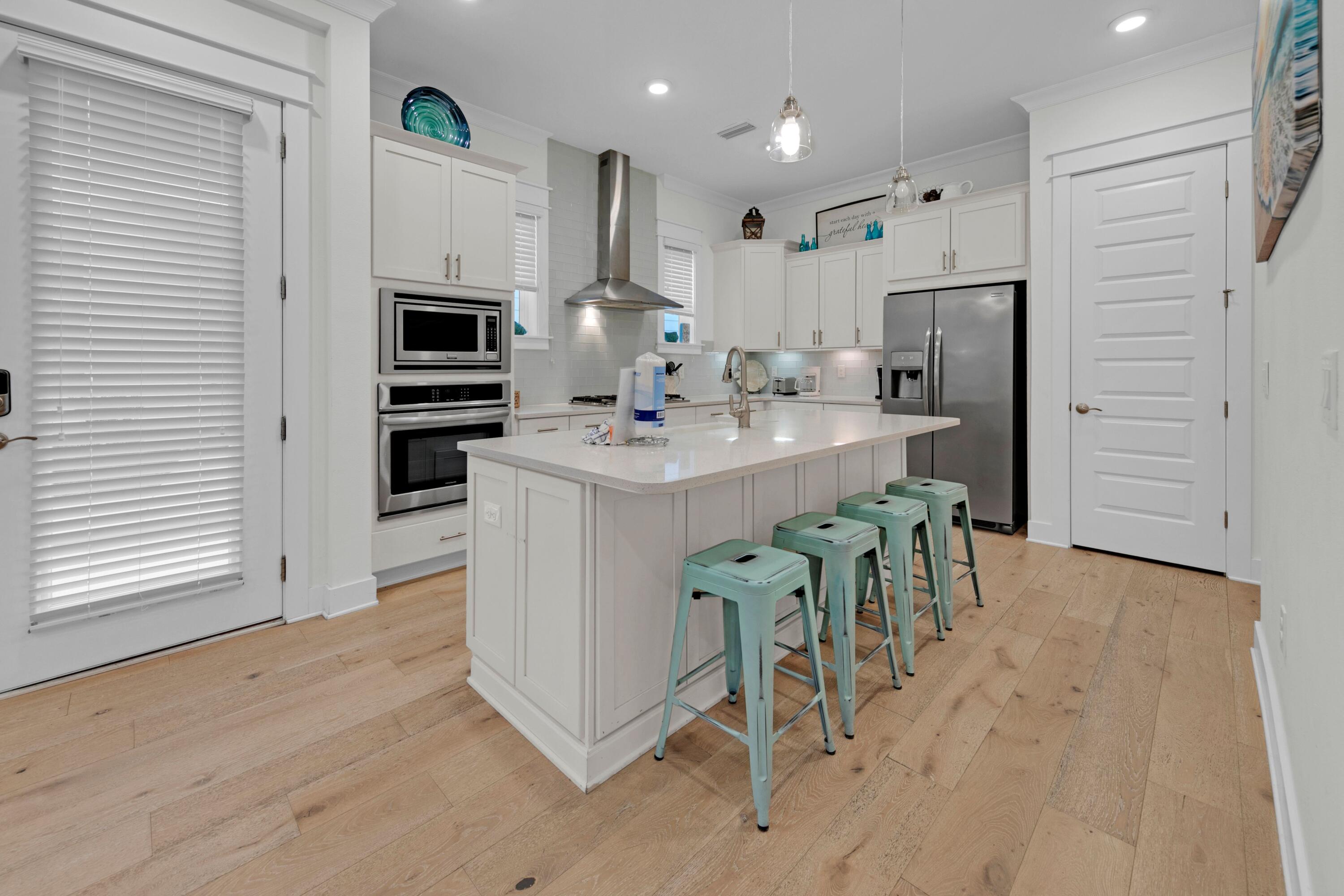 209 Milestone Dr Inlet Beach, Unit B Inlet Beach, FL 32461 - Photo 19 of 39 a kitchen with counter top space cabinets and stainless steel appliances