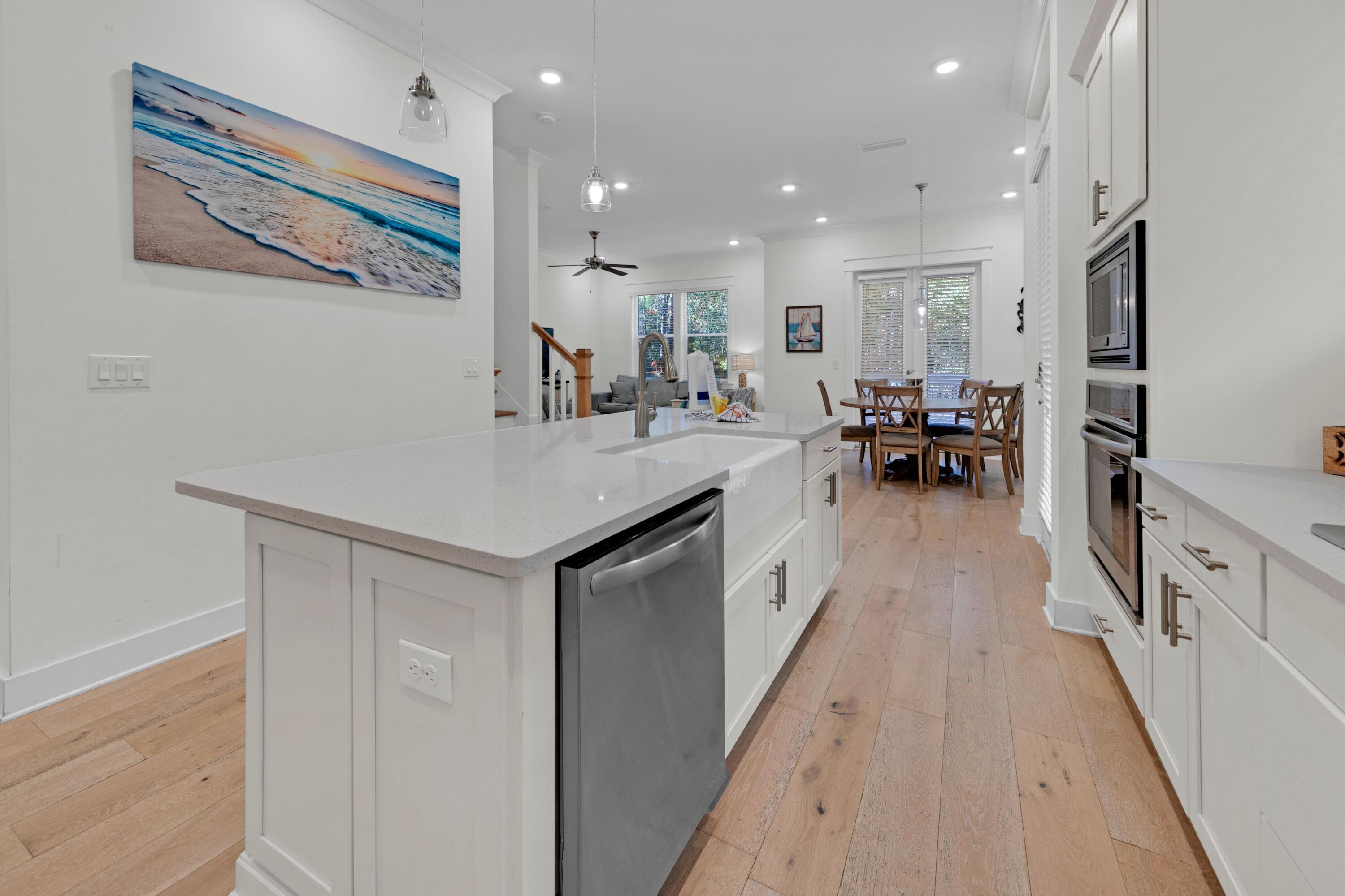 209 Milestone Dr Inlet Beach, Unit B Inlet Beach, FL 32461 - Photo 23 of 39 a kitchen with sink cabinets and living room