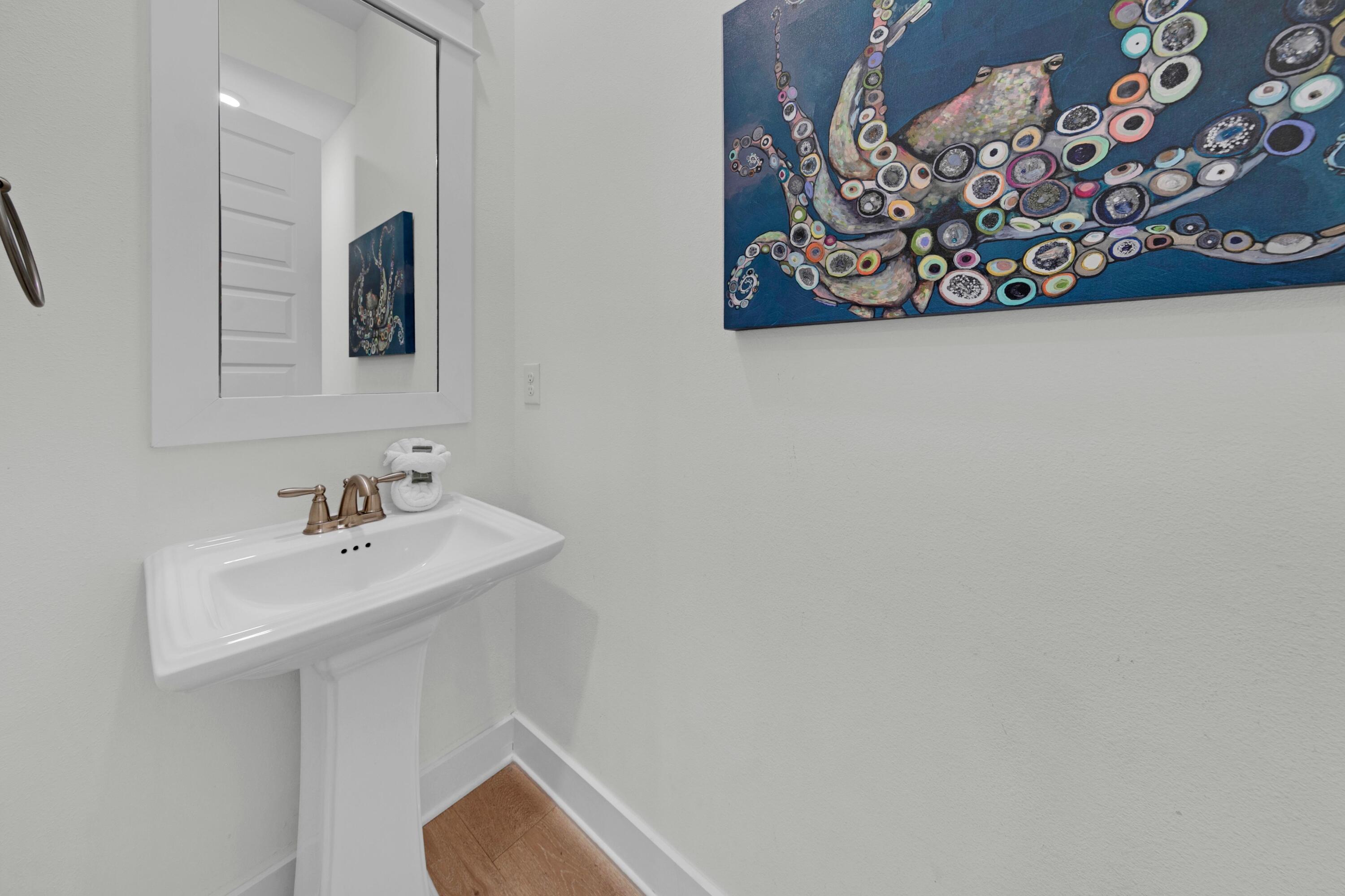 209 Milestone Dr Inlet Beach, Unit B Inlet Beach, FL 32461 - Photo 24 of 39 a bathroom with a sink mirror and vanity